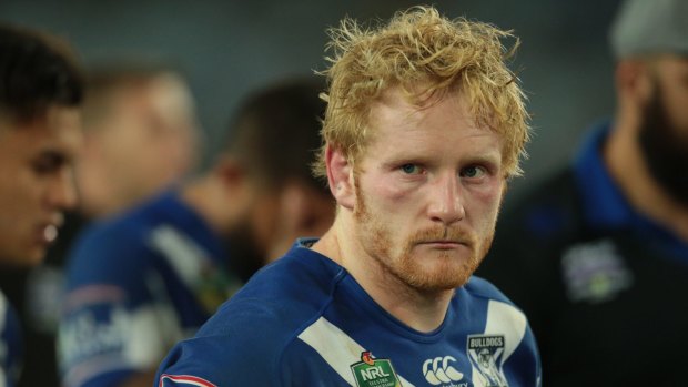 Down and out: Canterbury's James Graham comes to terms with defeat in the grand final.