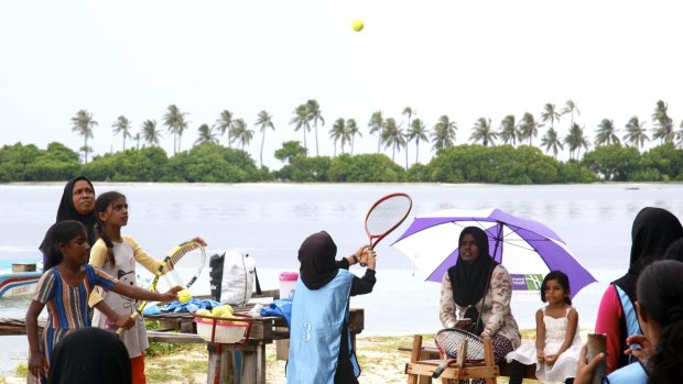 Girls playing the Maldivian game of basi.