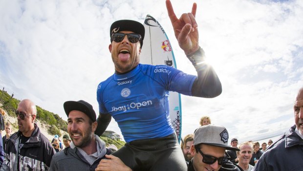 Back on top: Mick Fanning celebrates victory in South Africa.