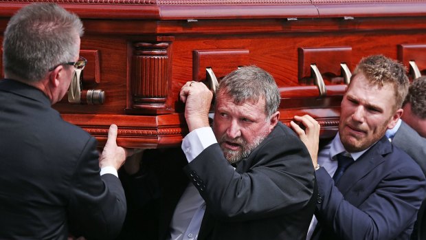 Tragic loss: Phillip Hughes’ father Gregory and Aaron Finch carry the coffin. 