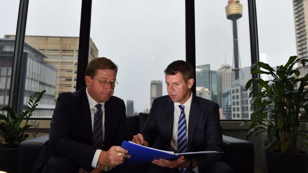 Hidden swings: Deputy Premier Troy Grant (left) and Premier Mike Baird get back to work after their election win.