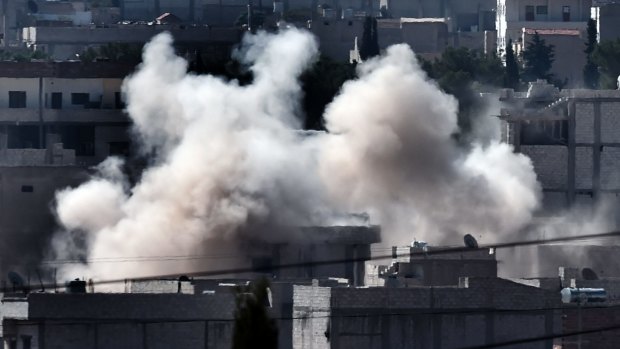 BATTLEFIELD: Smoke rises from Kobane as militants push to take the town.
