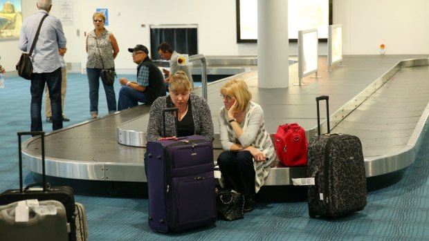 Passengers wait for news in the arrivals hall at Newcastle Airport.
