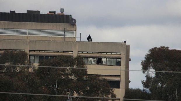 A police officer on the roof of the vacant former CSIRO headquarters in Campbell in May 2017 after reports of trespassing.