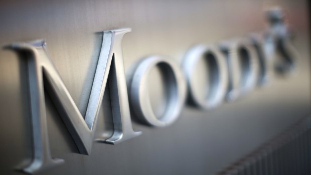 Moody's says banks' profit margins are being squeezed by record-low interest rates.
