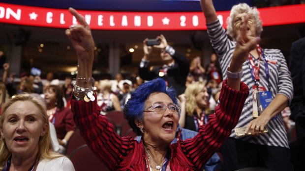 A delegate with blue hair cheers during the Republican National Convention in Cleveland, Ohio, in July. 