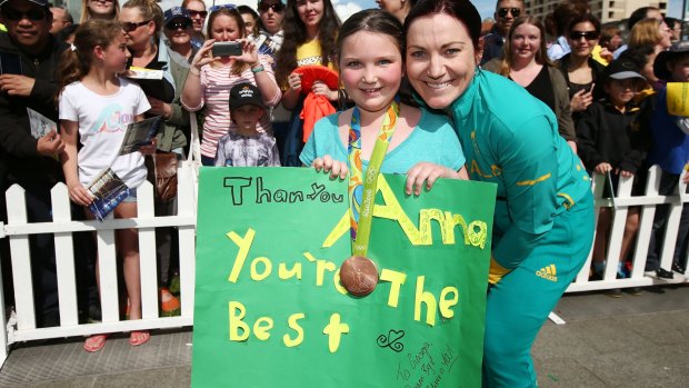 Legacy: Anna Meares shows her medal to a young fan after the Rio Games.