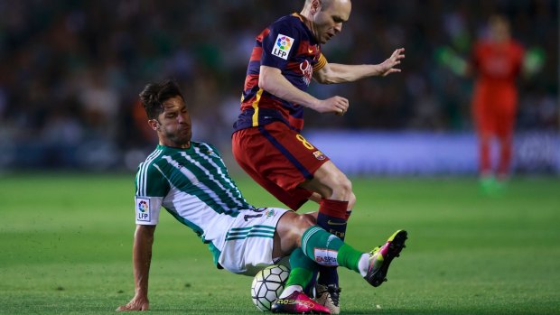 Top class: Western Sydney Wanderers signing Alvaro Cejudo tackles FC Barcelona's Andres Iniesta.