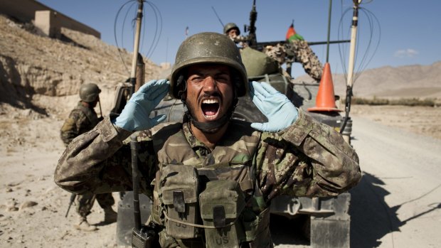 Afghan soldiers carry out a controlled detonation of a roadside bomb in Wardak province.