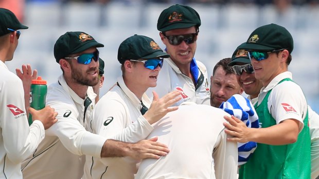 Australia's players congratulate Nathan Lyon (centre) after the dismissal of Bangladesh's Imrul Kayes.