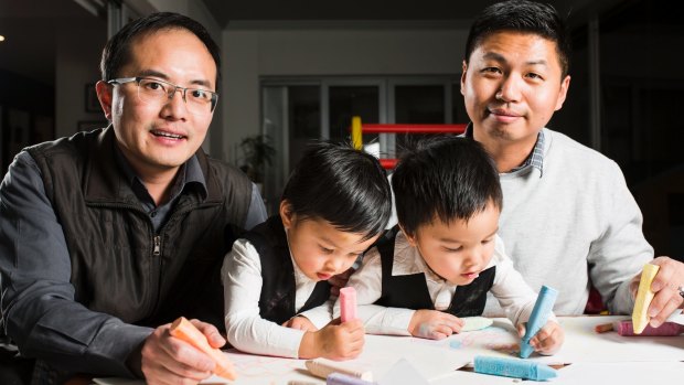 Chan Feng Lin-Wu and Travis Lin-Wu with their two and a half year old twins Jonathan (left) and Jeremy (right).