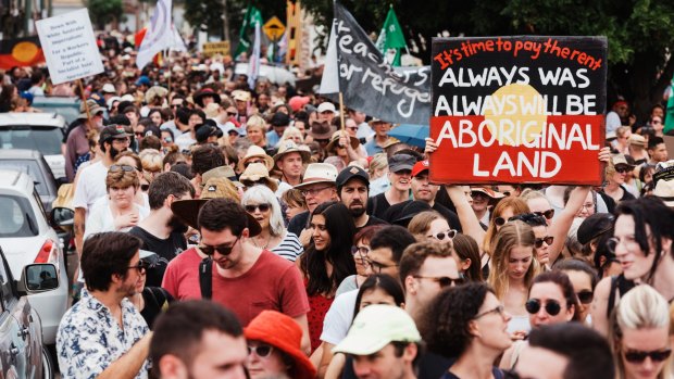 Marchers gather for the Invasion Day rally at The Block in Redfern on Friday. 