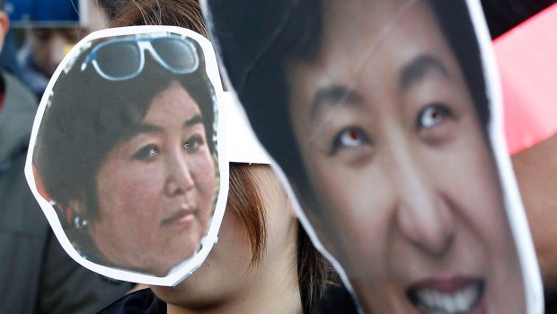 South Korean protesters wearing masks of South Korean President Park Geun-hye, right, and Choi Soon-sil, a longtime friend.