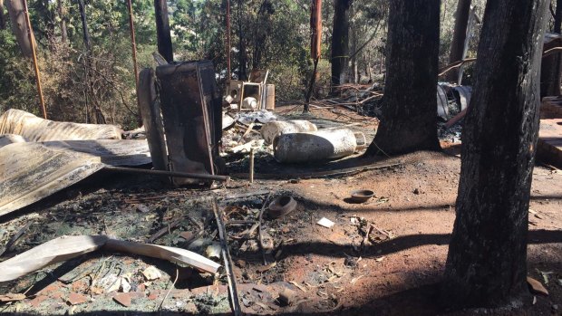 The burnt-out remains of  the Holden family holiday house, including the fridge Age editor-in-chief Andrew Holden bought for $50 two decades ago. 