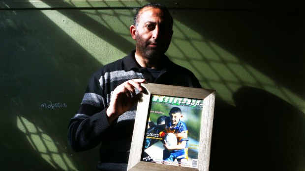 Grieving father: Azzam Hrouk with a picture of his murdered son, Mahmoud.