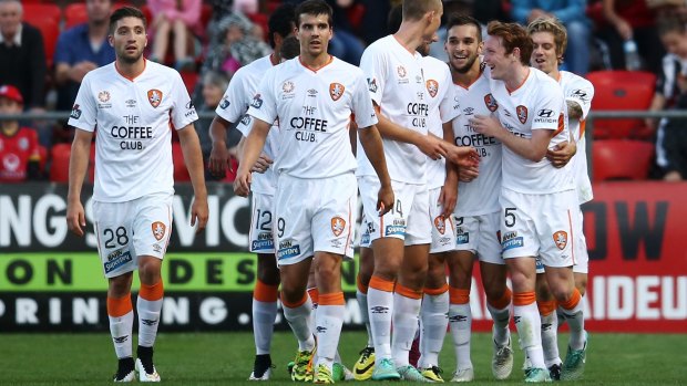 All white on the night:  Brisbane players congratulate Andrija Kaluderovic after his opening goal.
