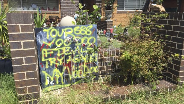 A sign written with yellow spray paint was displayed out the front of Nicholas Glezos' home on Wednesday.