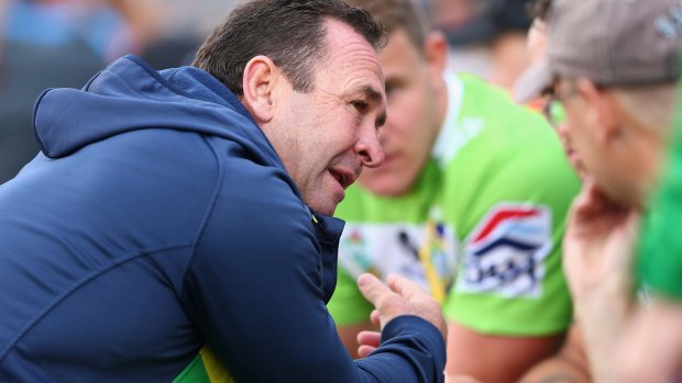 Raiders coach Ricky Stuart talks to players on the bench during the round seven NRL match against the Wests Tigers.