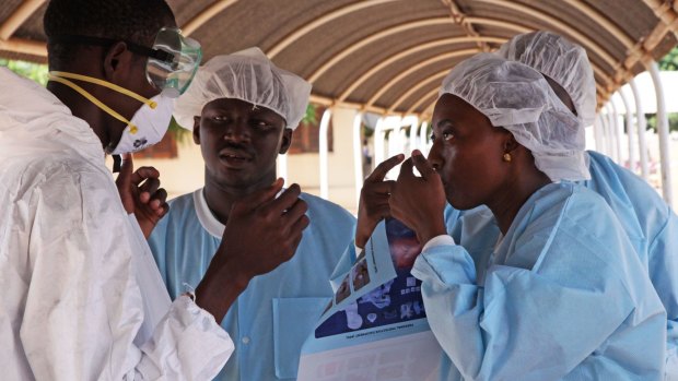 Monitoring symptoms: Health workers at an Ebola treatment centre in Mali.