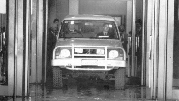 A police officer drives the Pajero out of the Parliament House foyer in 1992 after it was crashed into the building.