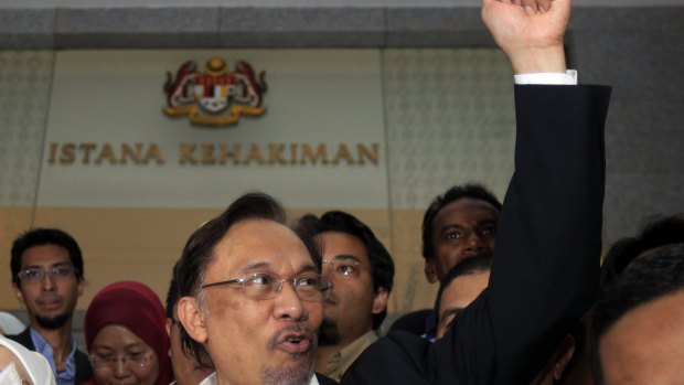 Malaysian opposition leader Anwar Ibrahim leaves court in March, 2014.