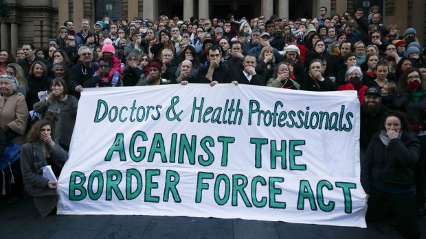 Doctors and health professionals at a Sydney protest last year. They stood with their hands over their mouths indicating they are being silenced by the new laws.