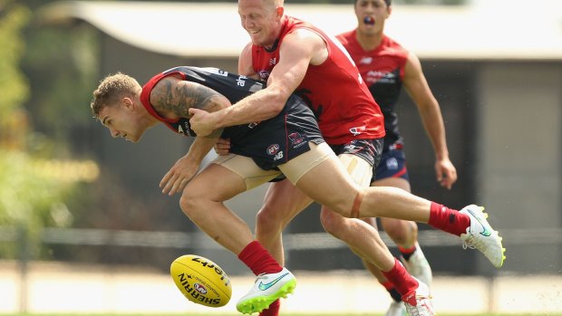 Holding on: The Demons' Dean Kent is tackled at the AFL Intra-Club match at Casey Fields on Thursday.