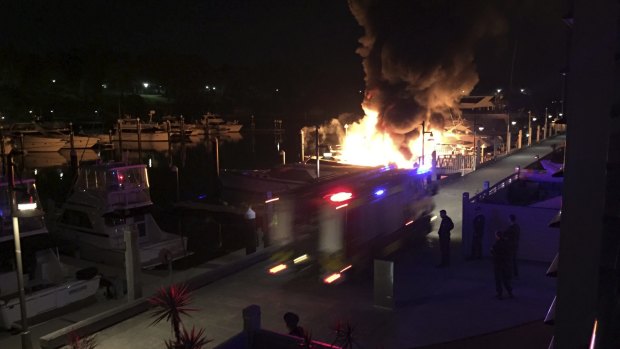 Firefighters at the Finger Wharf in Woolloomooloo at about 4am on Saturday as flames engulf two yachts.