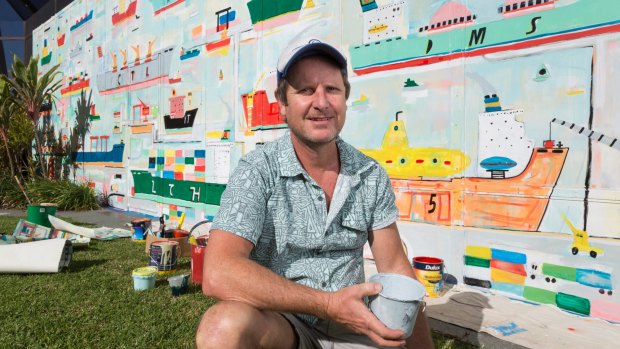 Brisbane artist Adam Lester with one of the large-scale murals he has completed to brighten up the walls of Lady Cilento Children's Hospital.