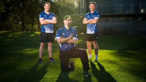 Joe Maloney, centre, with ANU cricketers Scott Murn and Owen Chivers. Maloney has become an important part of the Owls club.
