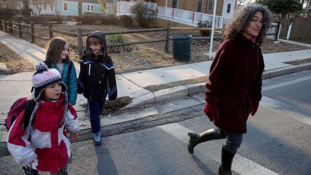 Danielle Meitiv, right, walks home with her daughter  Dvora Meitiv, 6, left, Rosie Resnick, 9, and her son Rafi Meitiv, 10.