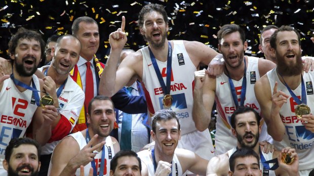 Powerful Pau: Pau Gasol, standing centre, celebrates with Spain's King Felipe VI, centre left, and teammates after winning the EuroBasket final against Lithuania at the Pierre Mauroy stadium in Lille, northern France. Spain defeated Lithuania in their gold medal match 80-63.
