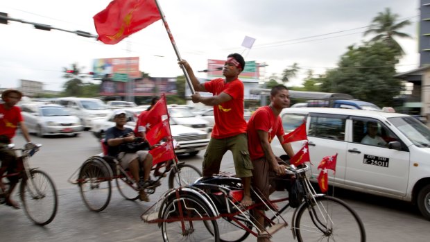 Members of Myanmar opposition leader Aung San Suu Kyi's National League for Democracy party rally on trishaws through a suburb in Yangon, Myanmar on Tuesday.
