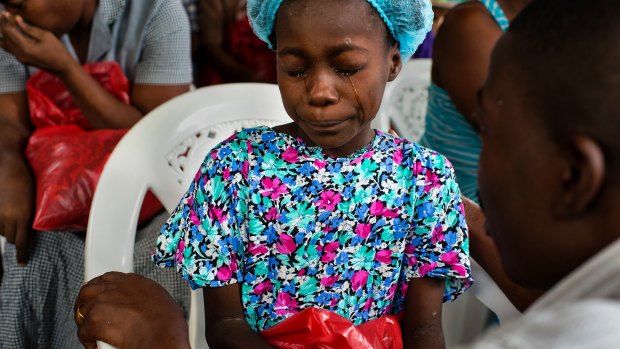 Michel du Cille took this photo of Esther Tokpah in September in Monrovia, Liberia. The 11-year-old had lost both her parents to Ebola.