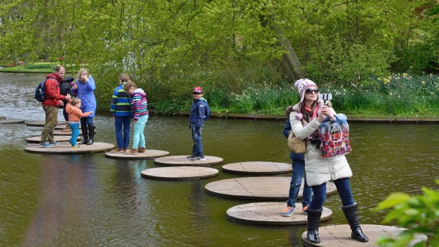 Negotiating the lily pad walkway over a pond at Keukenhof Gardens.
