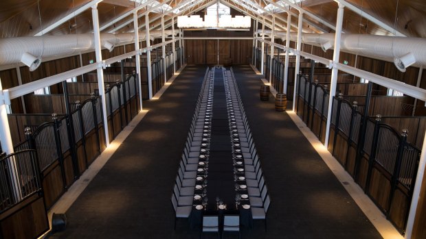 Opulent opening: The barn set with a large dining table at the Inglis Riverside Stables.