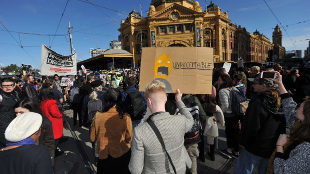 Protesters stop traffic outside Flinders Street Station, protesting against planned border protection raids.