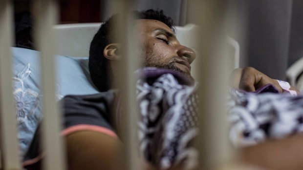 An Egyptian man sleeps in hospital after being rescued from the boat.