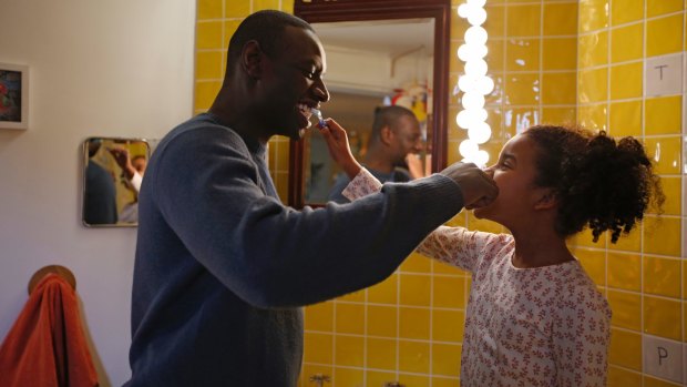 Cuter than a box of puppies: Gloria Colston and Omar Sy bond in Two is a Family.