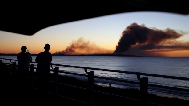 A giant plume of smoke can be seen from Cronulla at dawn.
