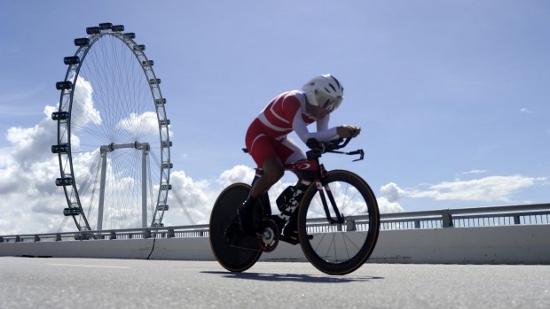 Back to normal: A cyclist competes at the SEA Games in Singapore on Thursday. 