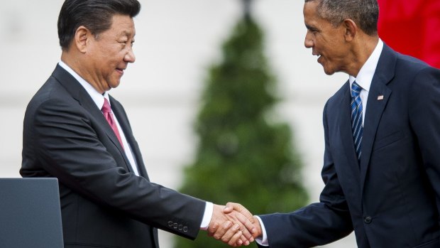 Chinese President Xi Jinping and US President Barack Obama shake hands during a ceremony on the South Lawn of the White House.