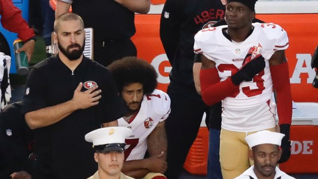 San Francisco 49ers quarterback Colin Kaepernick, middle, was the first player to kneel during the national anthem in September 2016.