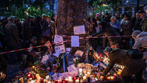 Flowers and candles are placed in memory of the attack's victims in front of Bataclan concert hall.