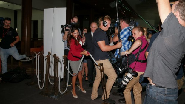 Members of the media almost trip over a bollard after a Parliamentary security guard put it in their way while interviewing Communications Minister Malcolm Turnbull.