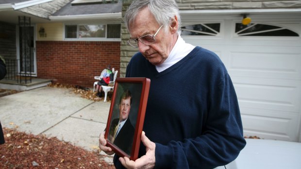 Jimmy Drake holds a picture of his son Darren Drake, a project manager who would ride along the Manhattan bike path listening to audio books. 