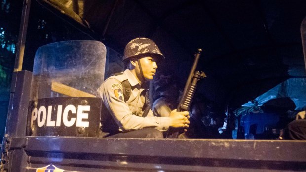 Police officers provide security in Yangon following violence against Muslims.