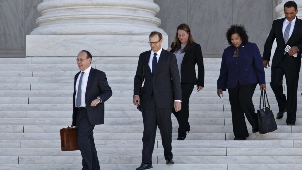Lawyers emerge from a Supreme Court hearing in Washington that will decide whether Amazon workers will be paid for undergoing daily security checks. 