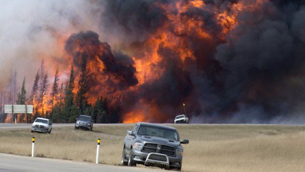A wildfire burns south of Fort McMurray, Alberta, near Highway 63 on Saturday.