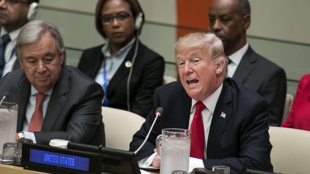 US President Donald Trump speaks at the United Nations as UN secretary general Antonio Guterres, left, listens during a panel discussion in New York.